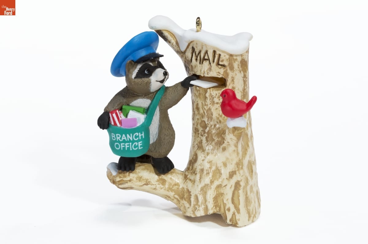 Hallmark "Mail Call" Christmas Ornament, 1989 Figurine of raccoon wearing cap and mailbag putting a letter into a slot in a tree trunk
