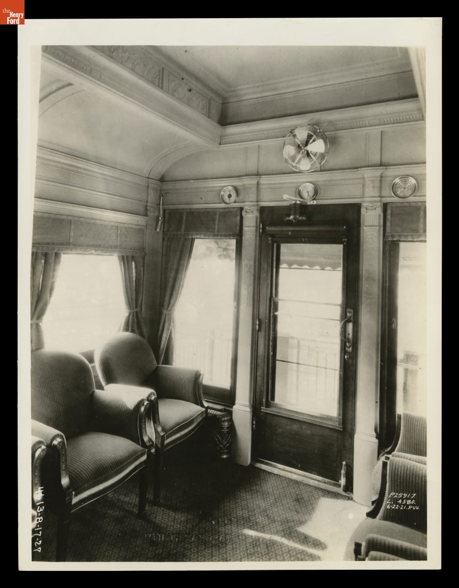 Corner of room with chairs, windows, and doors