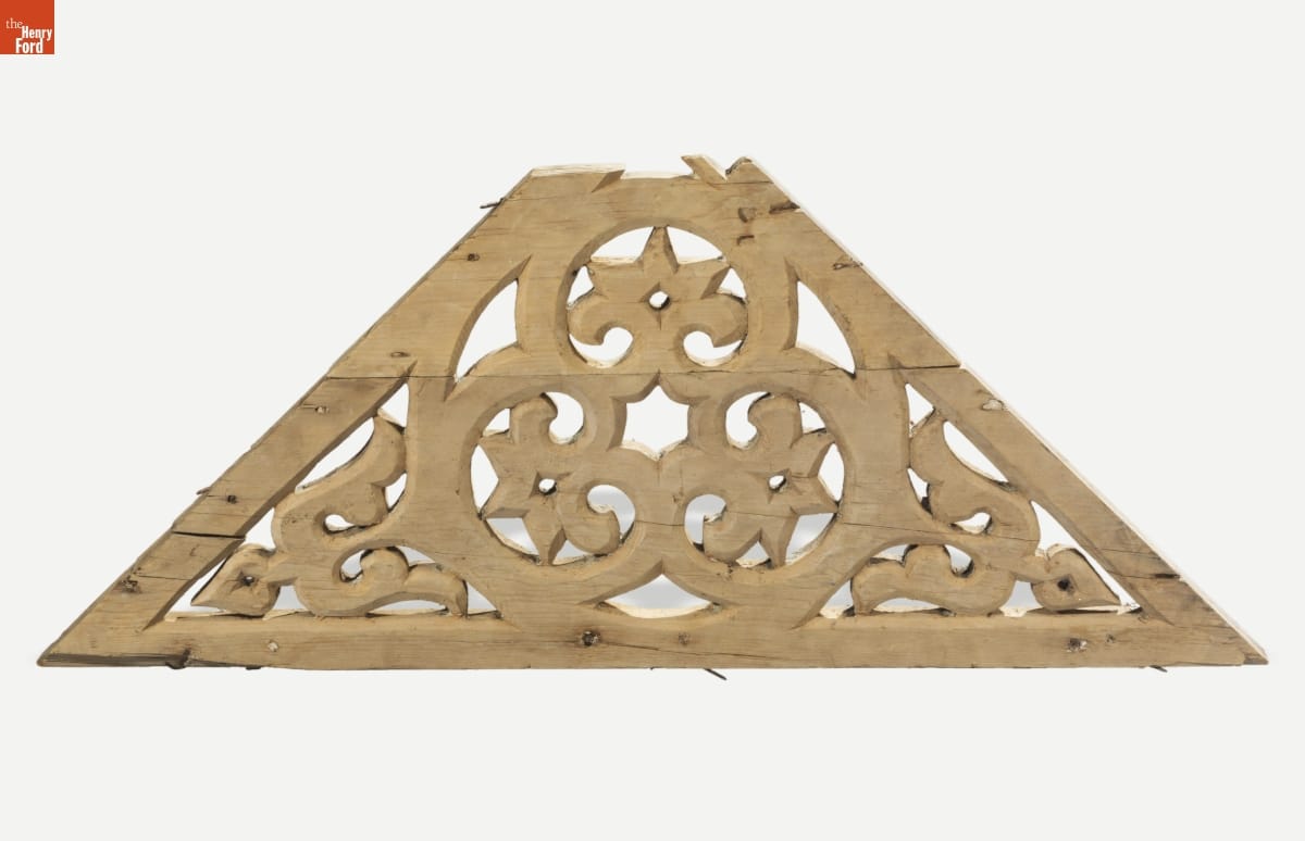 Triangular wooden bracket with scrolling design