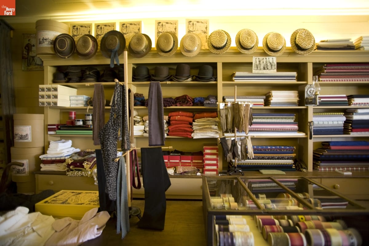 Store shelves and display cases holding clothing, fabric, and other items