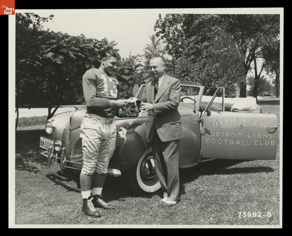 thf118251 Auto Dealer Stark Hickey and Detroit Lions Player Clem Crabtree with a 1941 Lincoln Zephyr