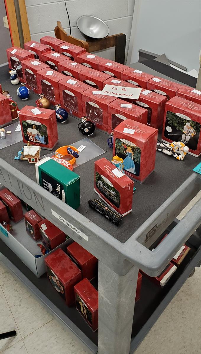 Red boxes and loose ornaments on two-level cart