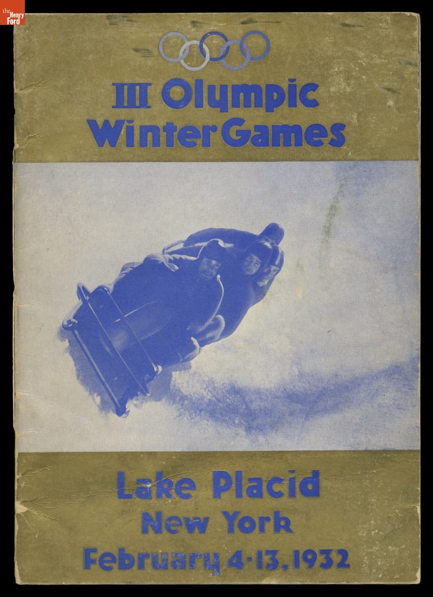 Gold cover with blue text and blue-and-white image of bobsledding