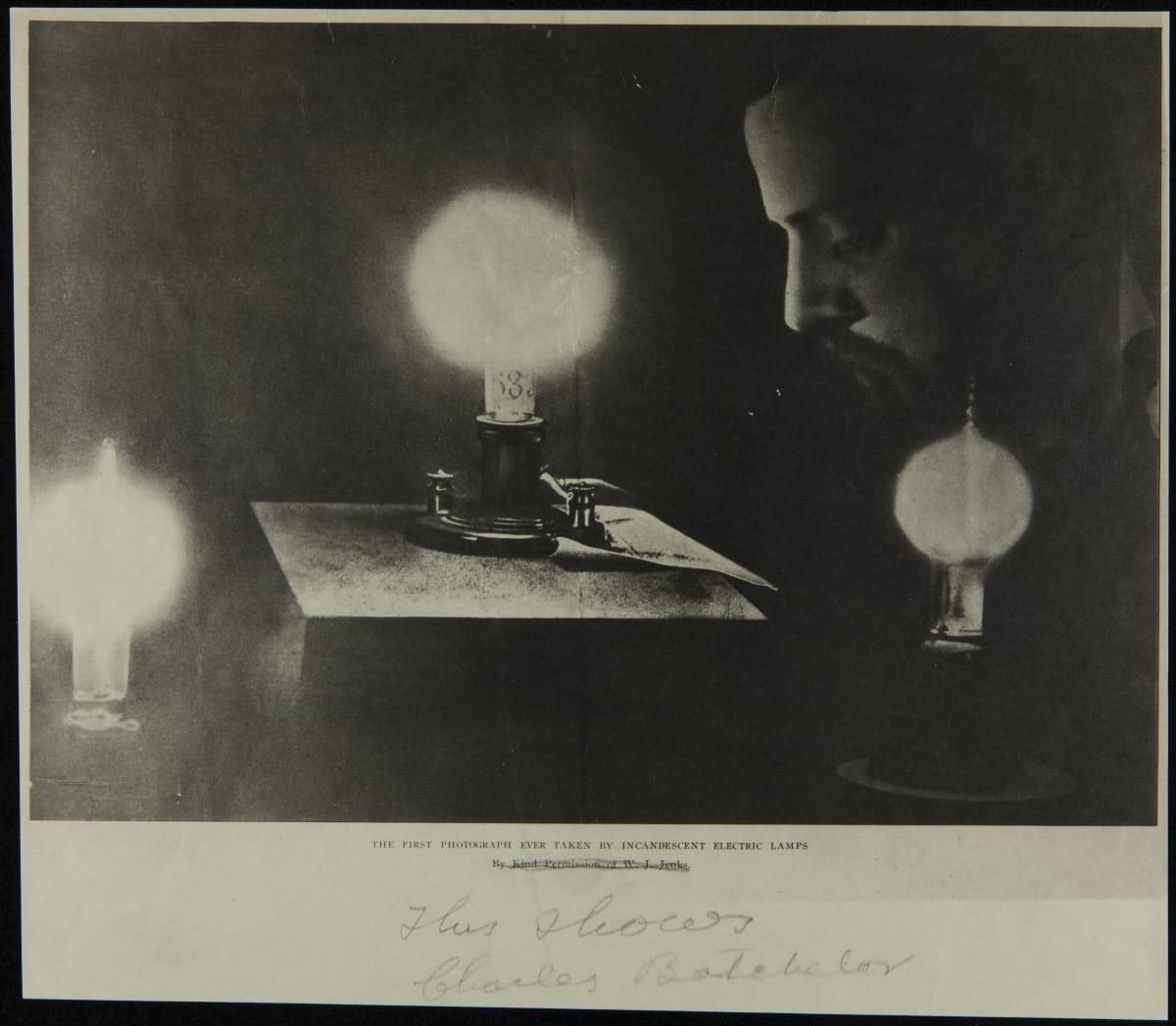 Man bows his head, eyes closed, among three illuminated light bulbs