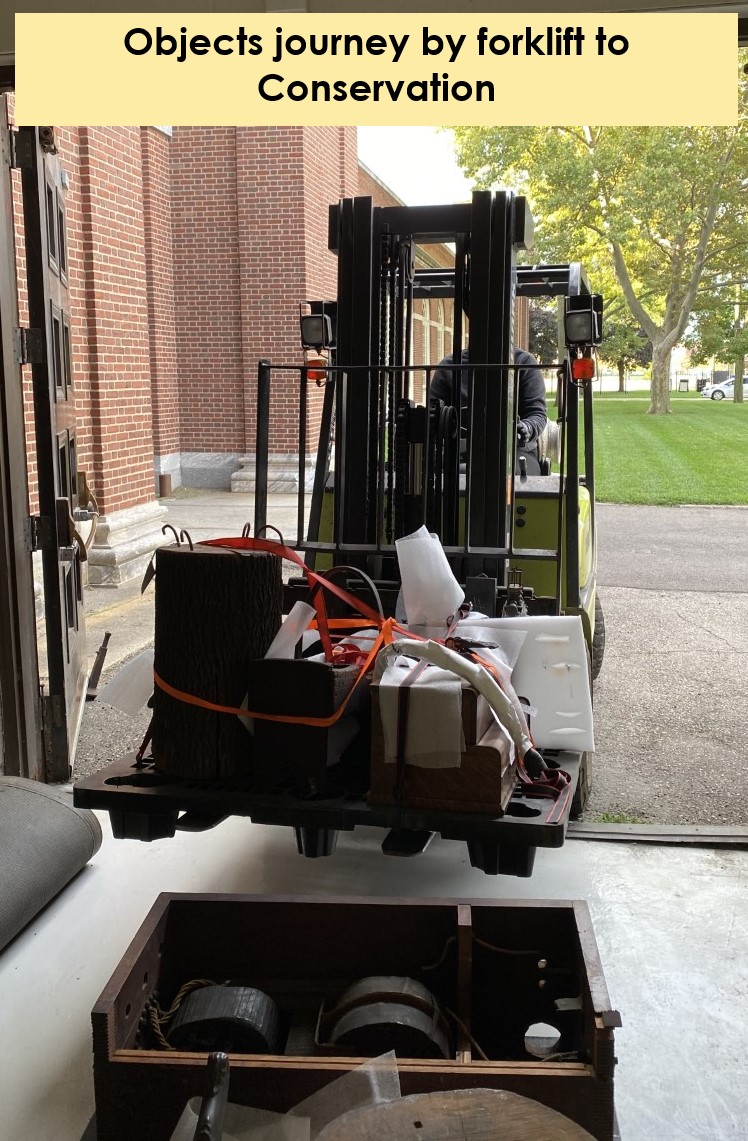 Front view of forklift loaded with bundles at large door