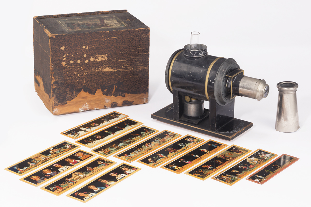 Ernst Plank Company Magic Lantern, No. 903, 1870-1900 Wooden box, strips of translucent images, and small metal and glass machine