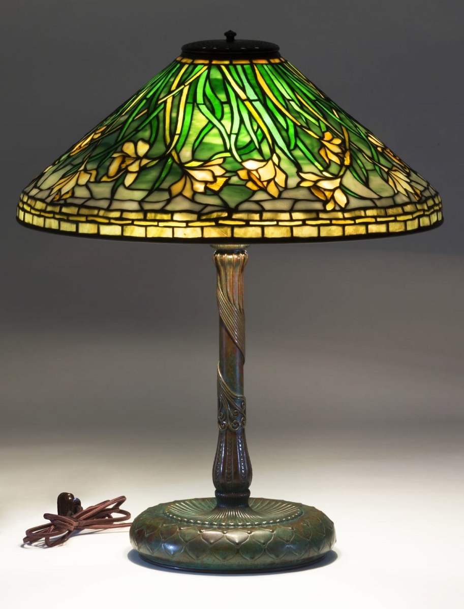 Bronze table lamp with glass shade with pattern of green and yellow daffodils