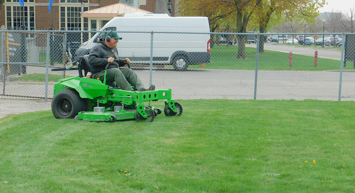 Staff member riding the Evo electric zero-turning riding mower.