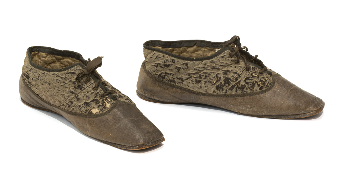 Brown shoes with leather at bottom and quilted fabric above, tied with laces