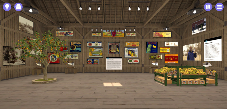 Barn-like space with orange tree growing on left side, crates of fruit on right side, various images on walls