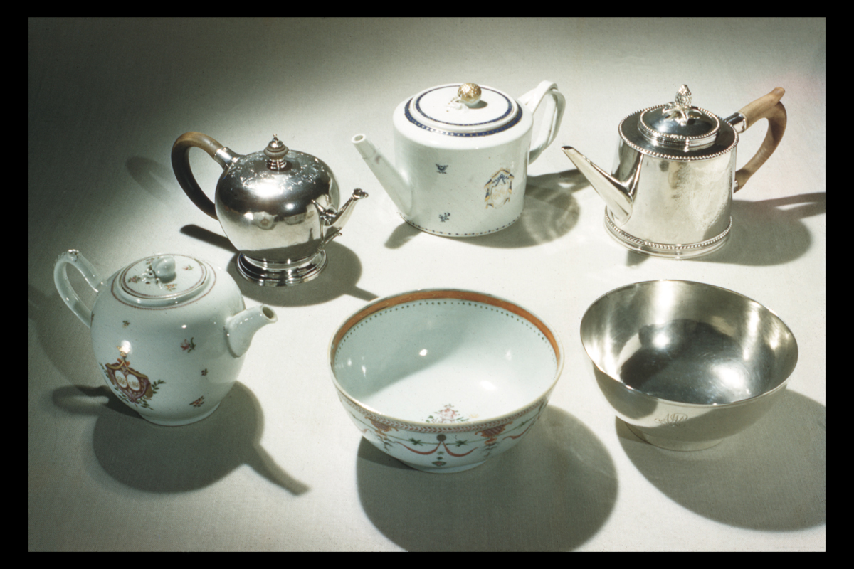 Sets of similarly shaped housewares, with one each in silver and ceramic, including two cylindrical teapots, two more spherical teapots, and two bowls