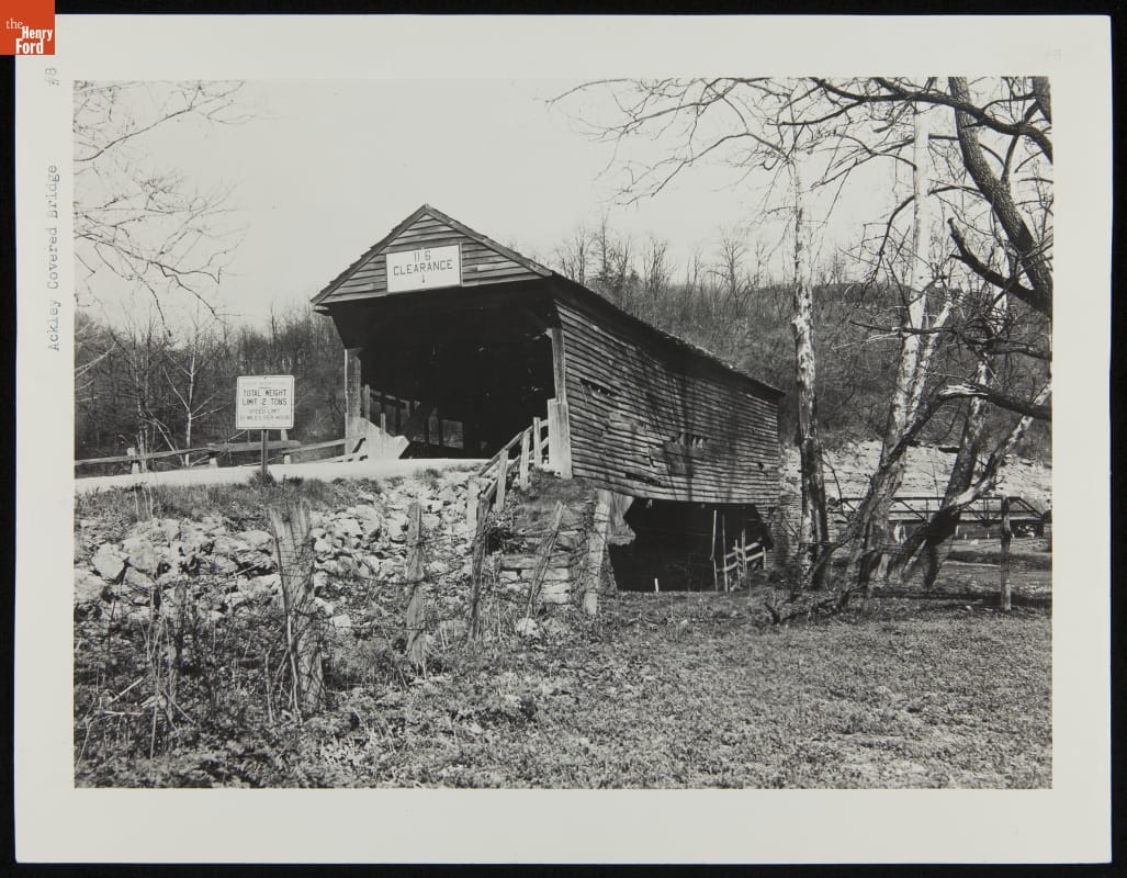 Somewhat ramshackle-looking covered bridge among woods