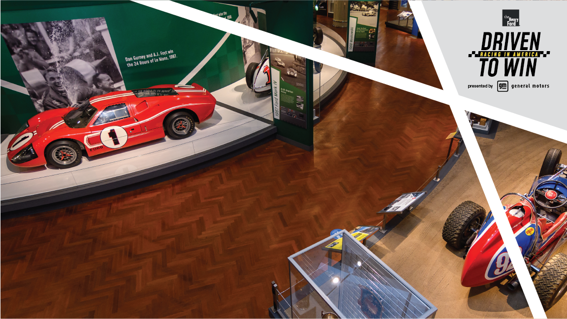 The 1967 Ford Mark IV Race Car and the 1958 Moore/Unser Pikes Peak Hill Climb Racing Car in Driven to Win Aerial view of museum exhibit featuring low red race car with number 1 in circle on side and hood, along with red and blue open race car