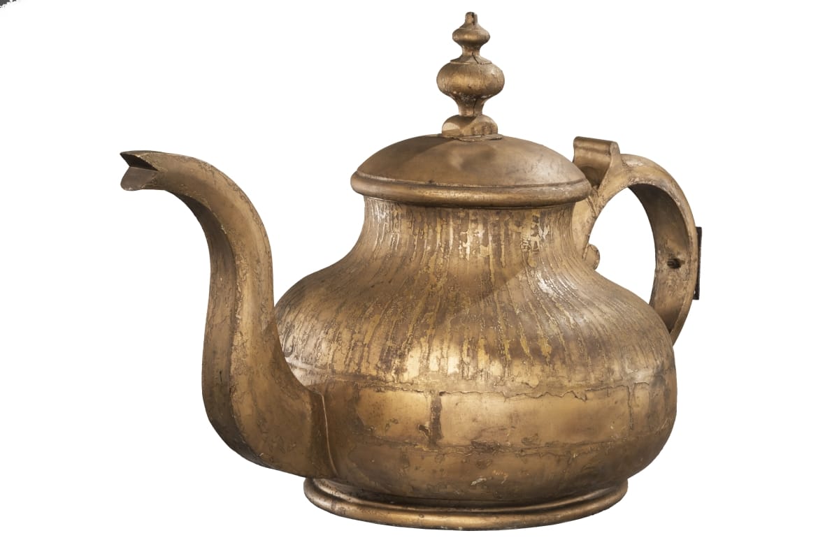Large golden teapot with long spout