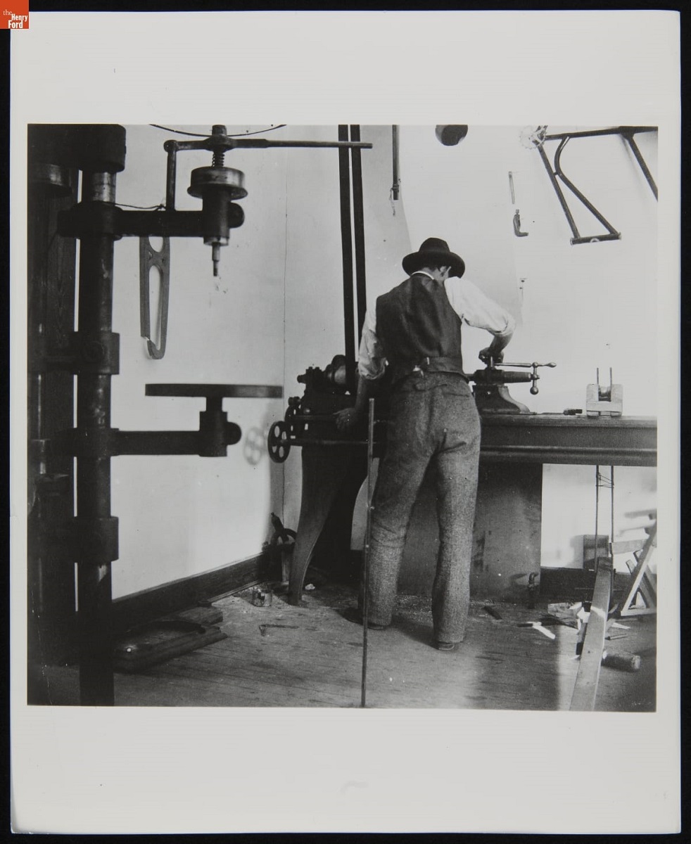 Back view of man working at a table in what appears to be a workshop