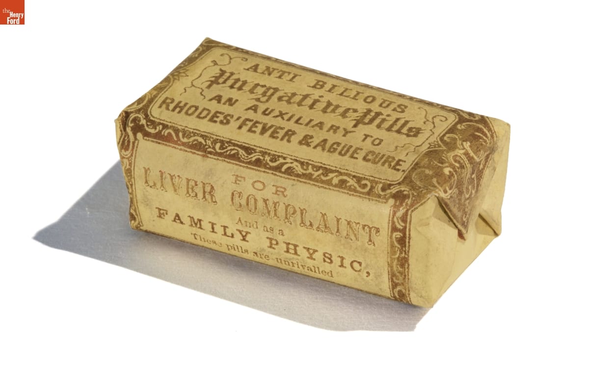 Rectangular yellow paper package (similar to a wrapped bar of soap) containing decorative edging and text