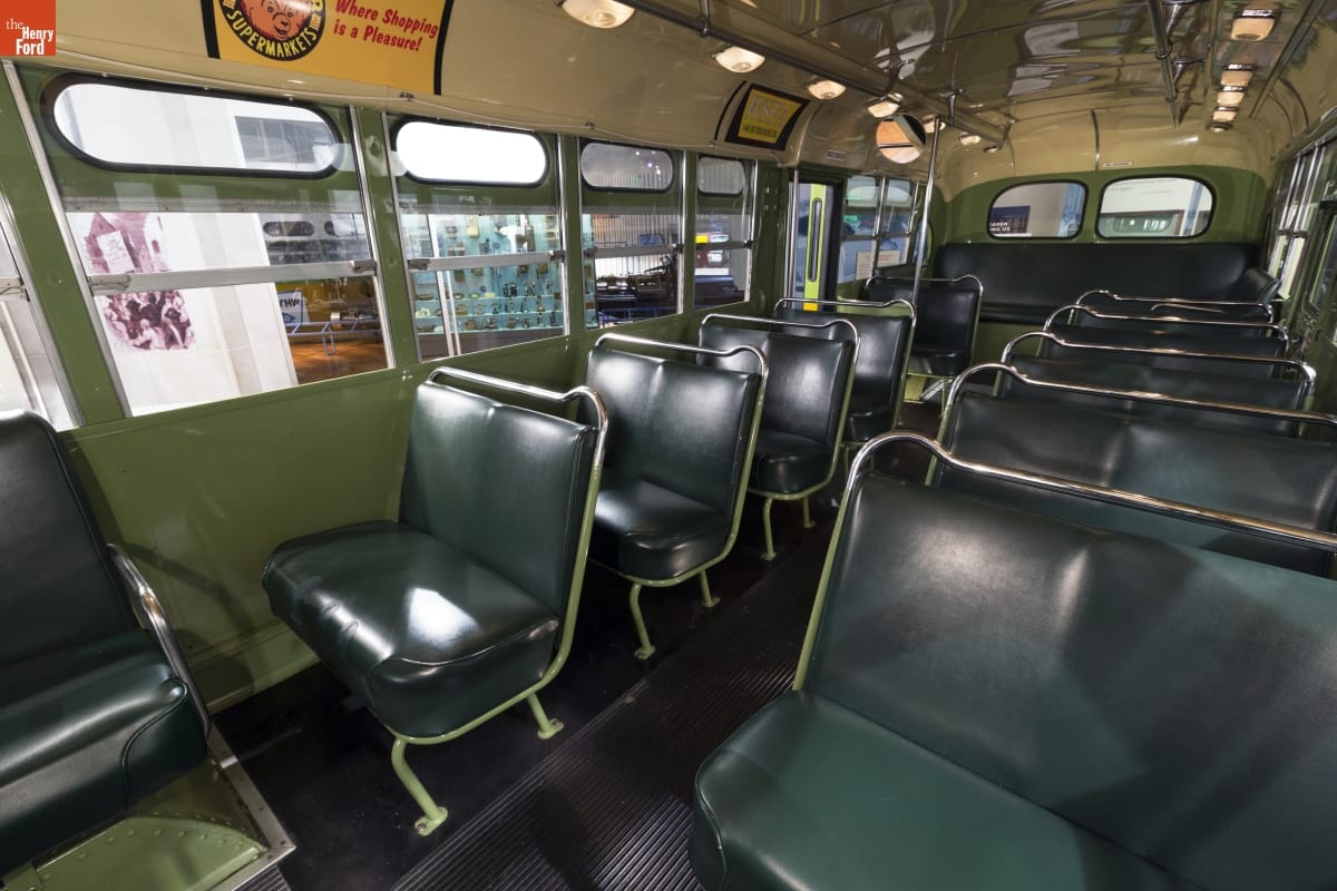 Interior of a bus with green bench seats