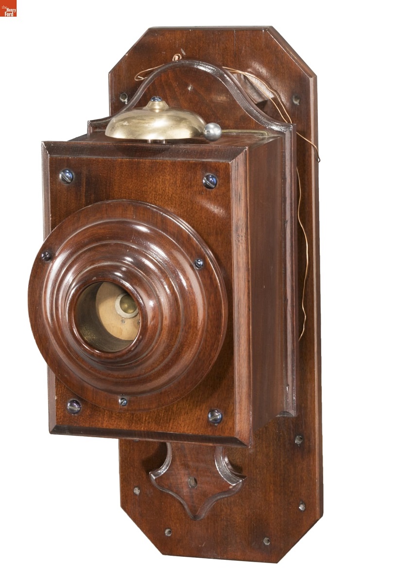 Wooden telephone designed for wall mounting; bell on top