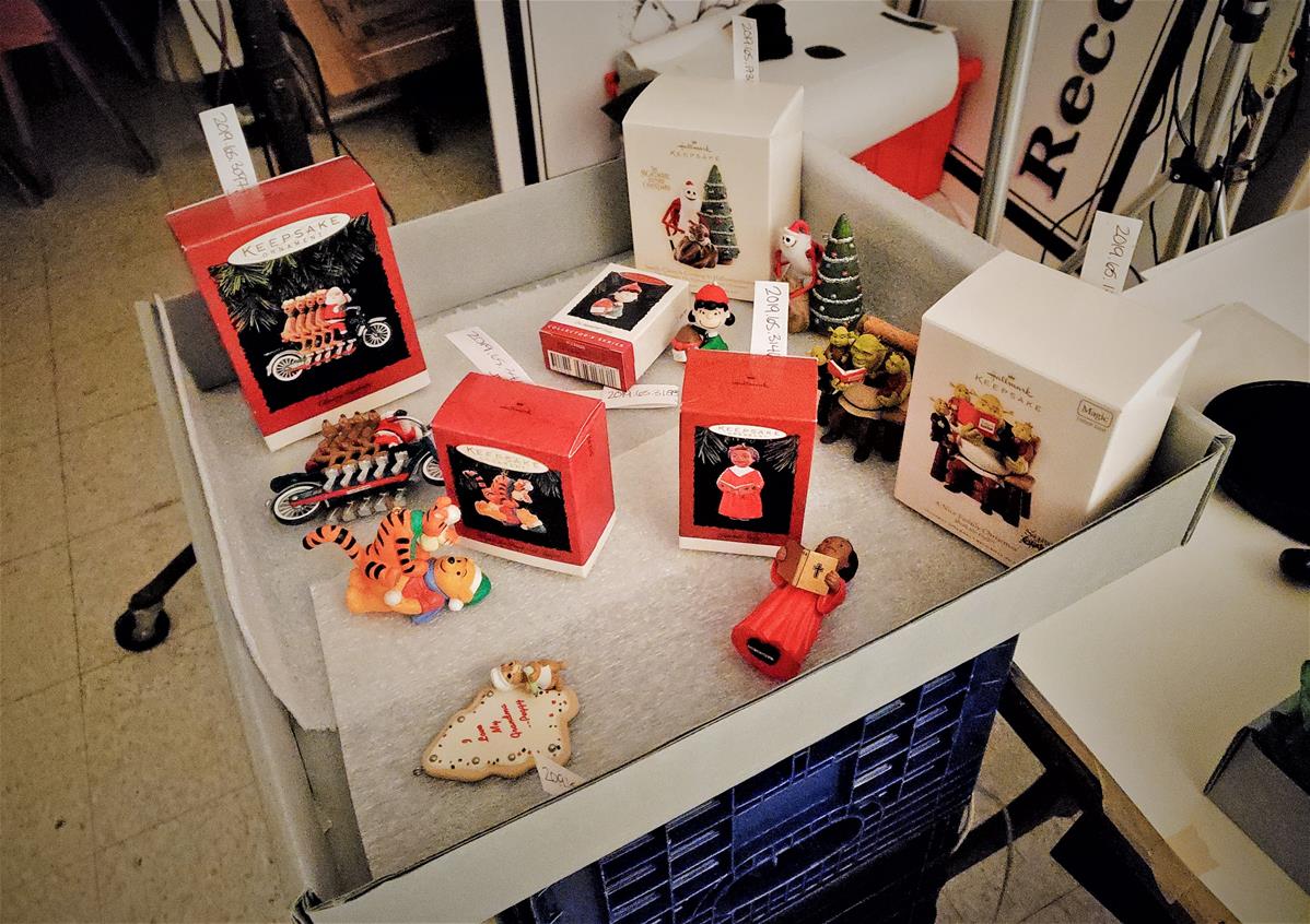 Christmas ornaments and boxes in large, flat, open gray box