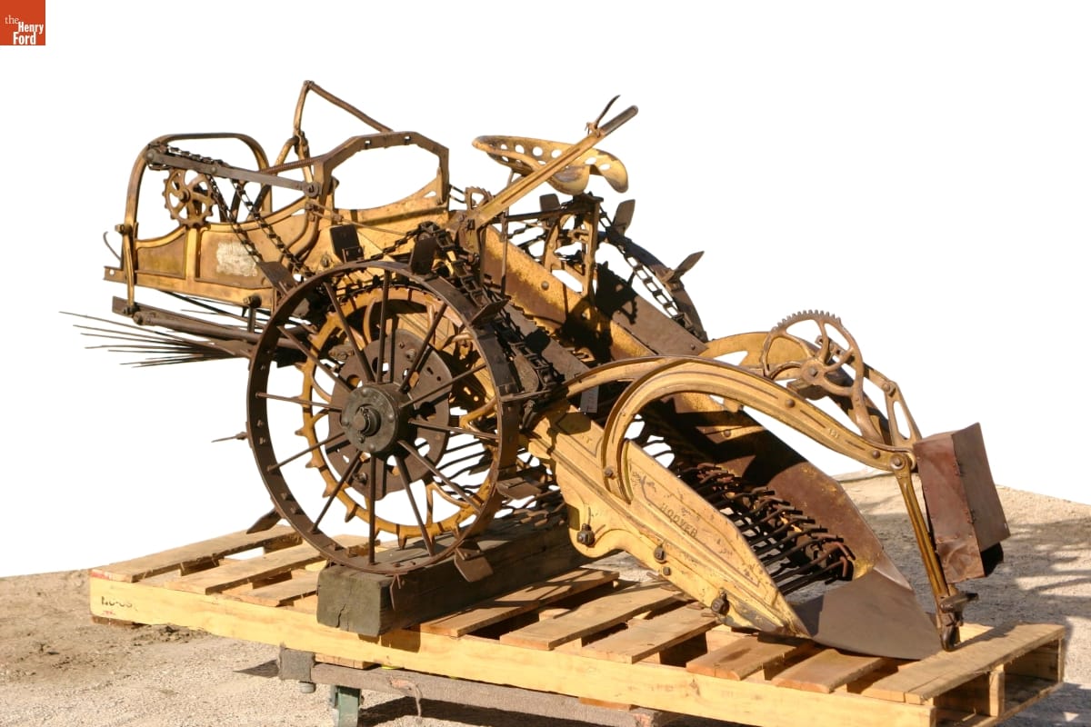 Potato Digger, 1913 Machinery with wheels, gears, and what appears to be a conveyor belt