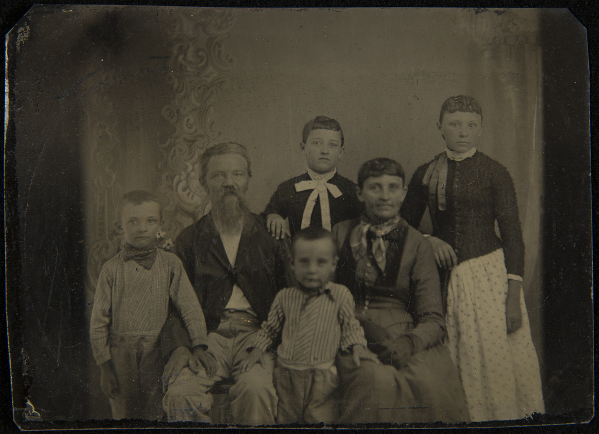 Group of people sitting and standing, posed for a portrait
