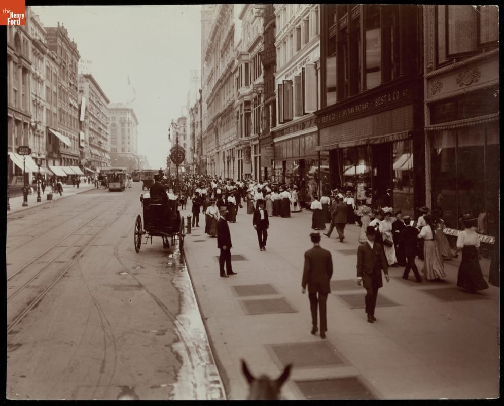 "West 23rd Street, New York City," circa 1908 Street scene, with tall buildings, carriages, and pedestrians