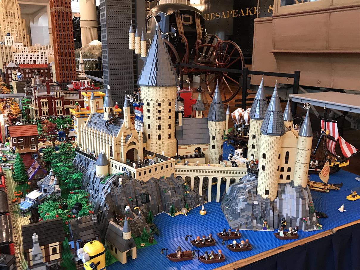Michigan LEGO Users Group (MichLUG) LEGO layout in Henry Ford Museum of American Innovation Extensive LEGO layout with boats and castle in foreground, buildings in background, and unrelated museum artifacts behind the layout