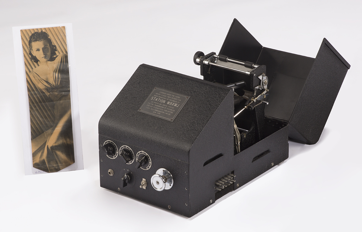 Finch Facsimile Transmitter, 1938-1940 Piece of equipment next to image of woman