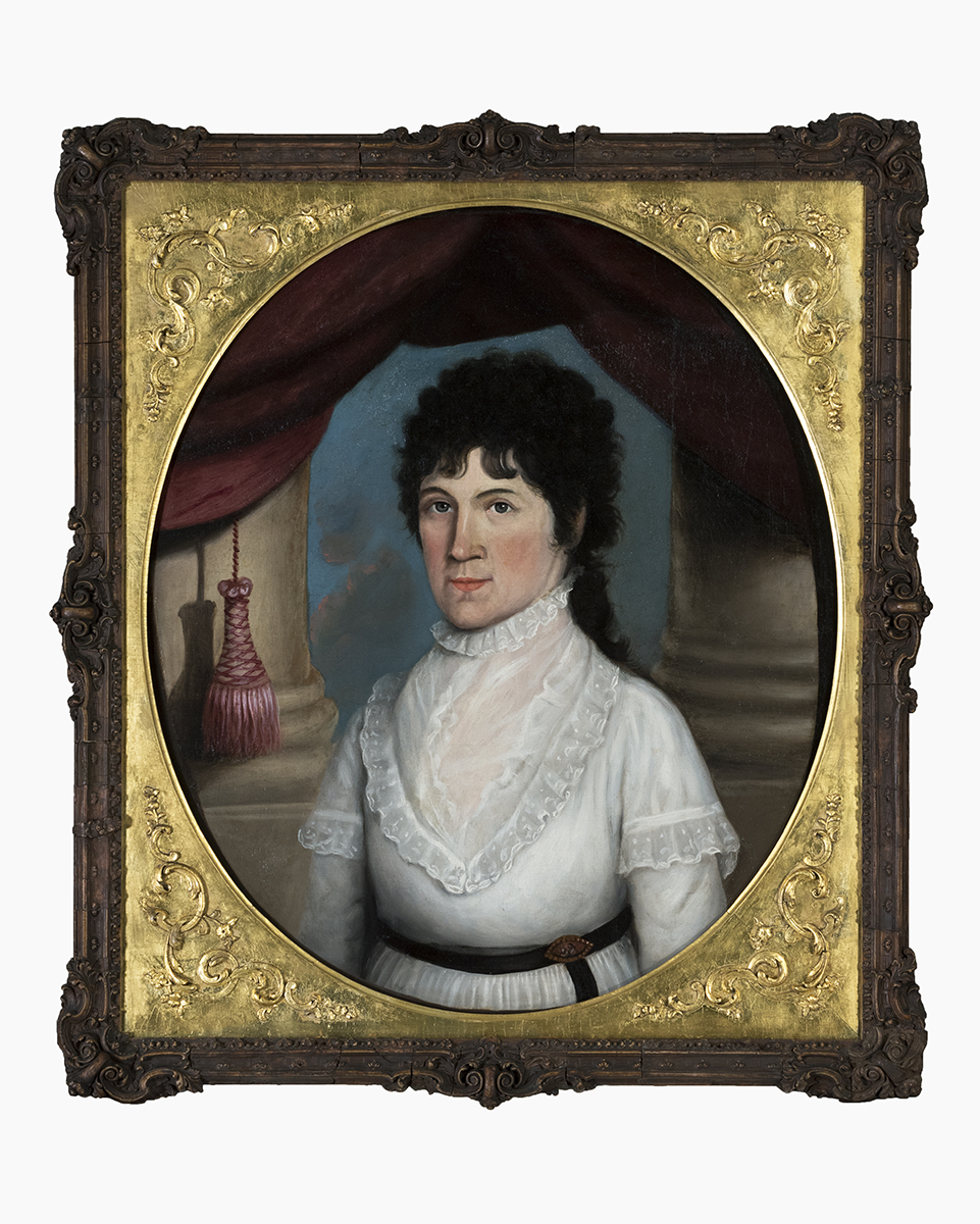 Oval painting in elaborate gold and dark frame of woman in white dress with dark curly hair standing between two large columns