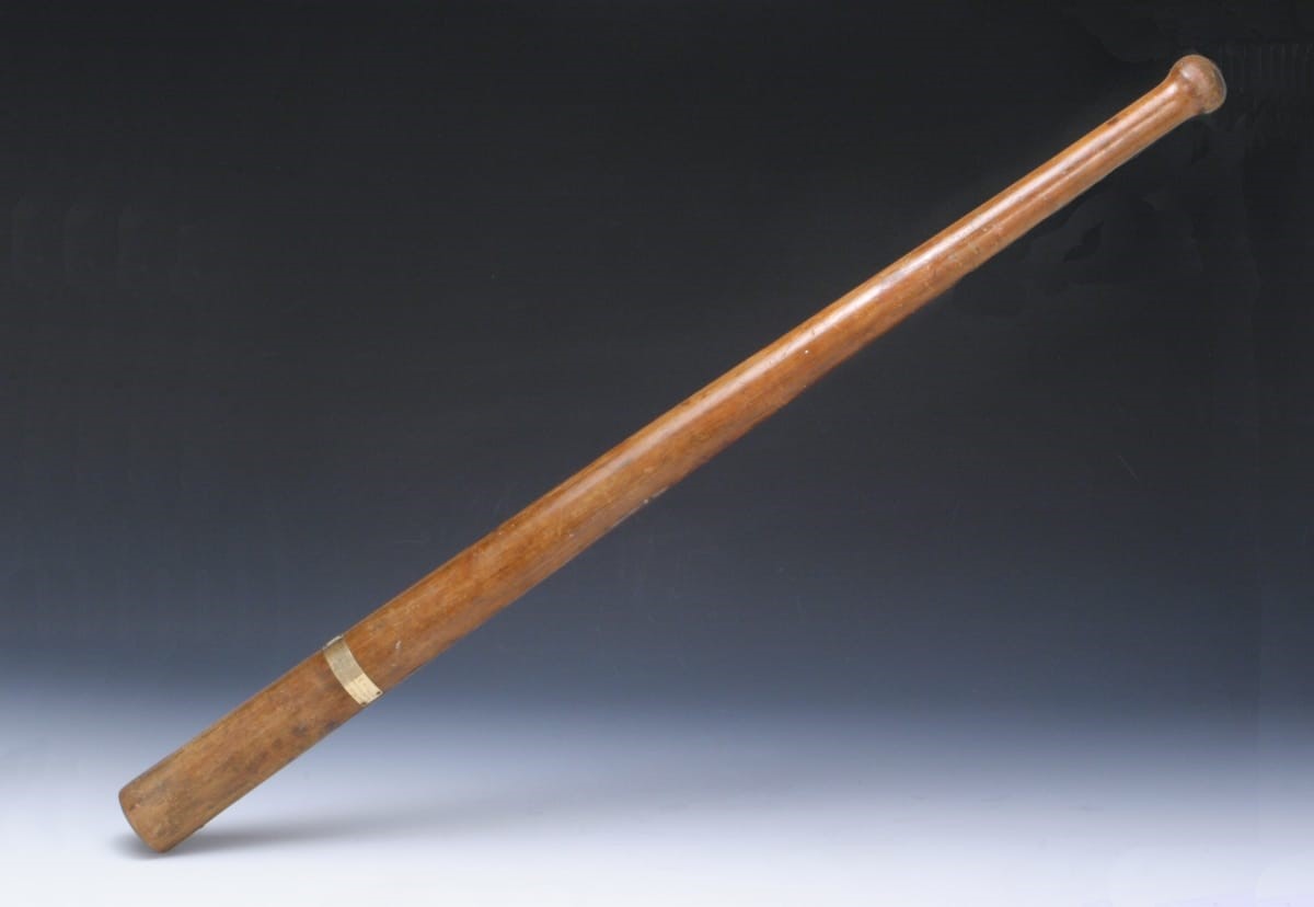 Baseball Bat Presented to John L. McCord for First Prize at the World's Tournament of Base Ball, 1867 Long, thin, wooden baseball bat with a small gold plaque on one end
