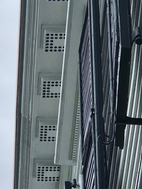 Architectural elements of white boxes with round holes in a "U" pattern in them