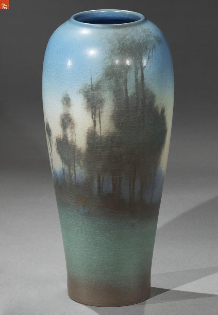 Pottery vase with impressionistic landscape scene in blues and greens