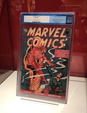 Marvel Comics #1 from 1939 in "Marvel: Universe of Super Heroes" exhibit Comic book cover with images and text in case