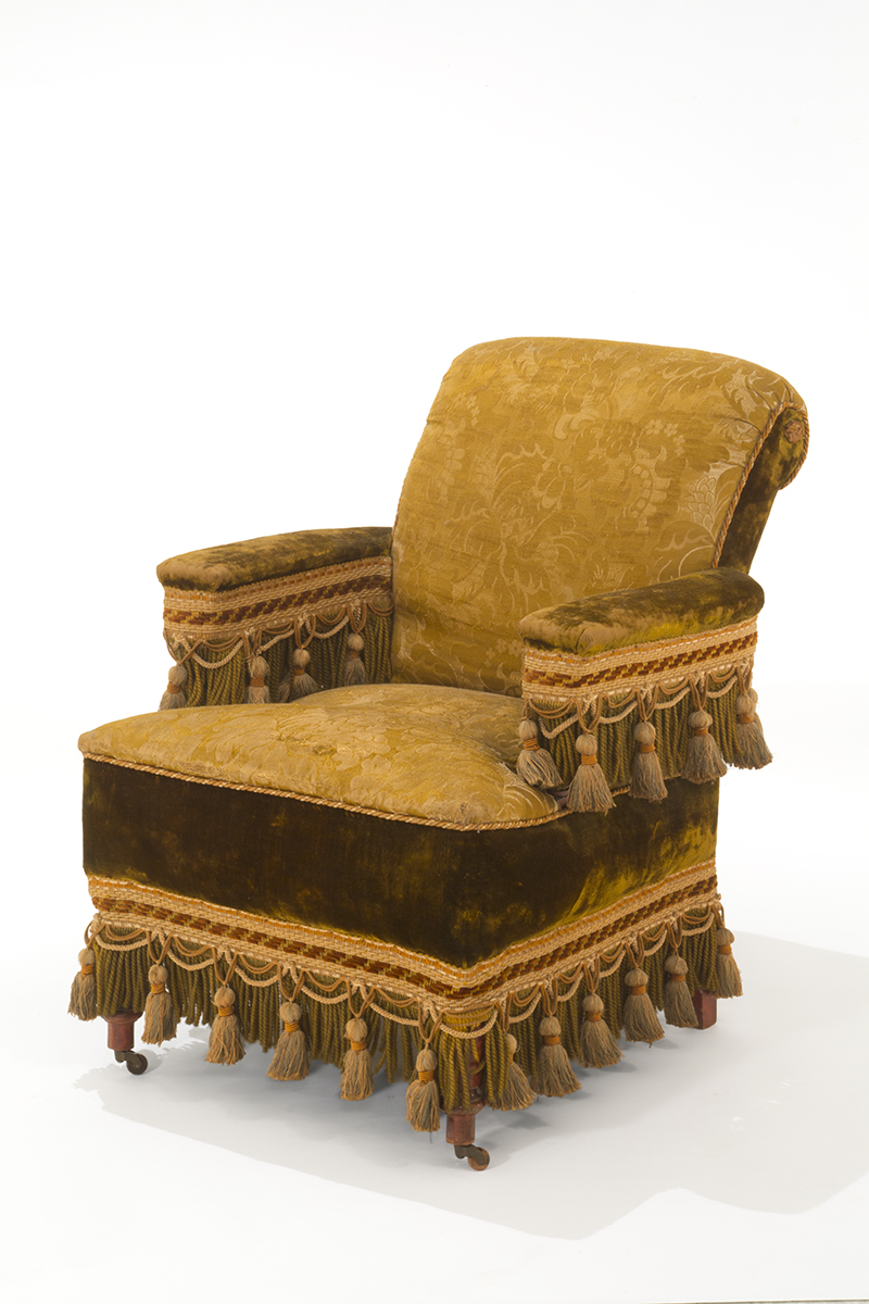Armchair from "Turkish" Parlor Set, 1885-1895 Upholstered yellow chair with multiple types of fabric, decorated with many large tassels