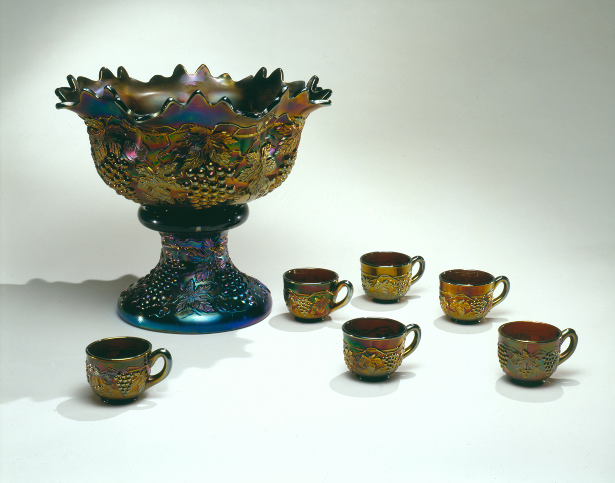 Elaborate blue and gold iridescent punchbowl and 6 cups