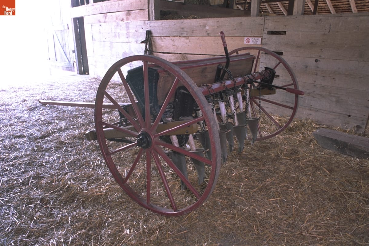 Wooden equipment on wheels, with many cone-shaped devices pointing downward