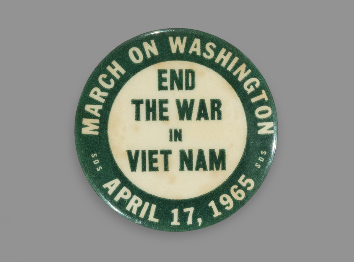 Button, "March on Washington, End the War in Vietnam, April 17, 1965" Round button with green border and white center; contains text