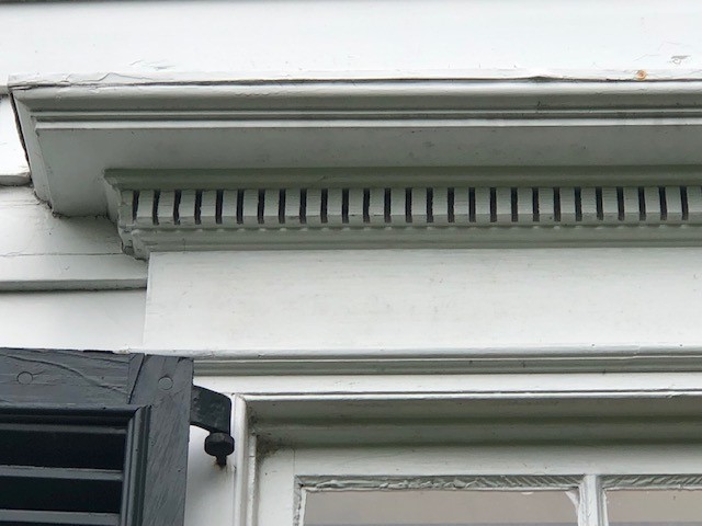 Close-up of decorative trim above a window