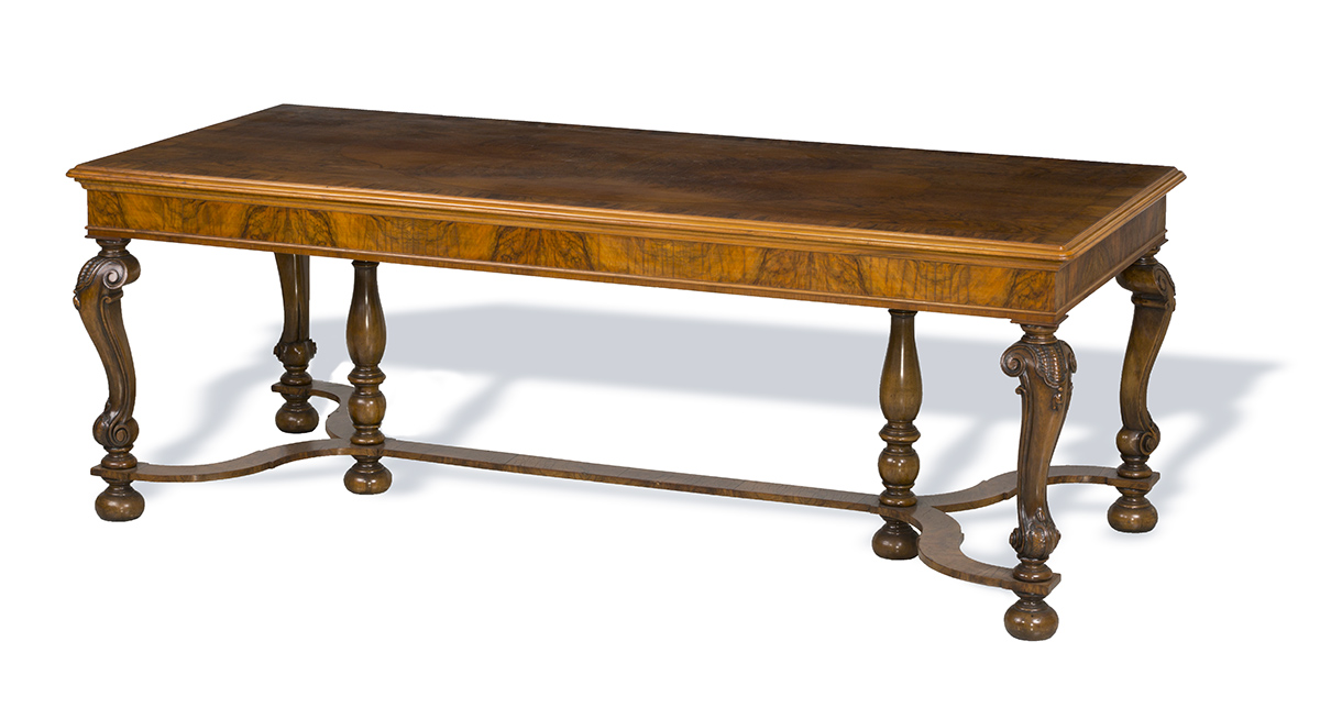 Long, narrow wooden table with decorative legs