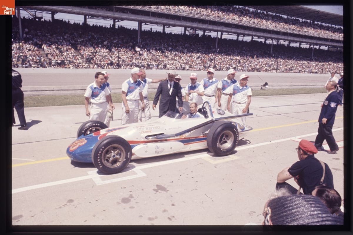 Parnelli Jones and his teammates at Indianapolis Motor Speedway in 1963. J.C. Agajanian, is in the suit and cowboy hat.