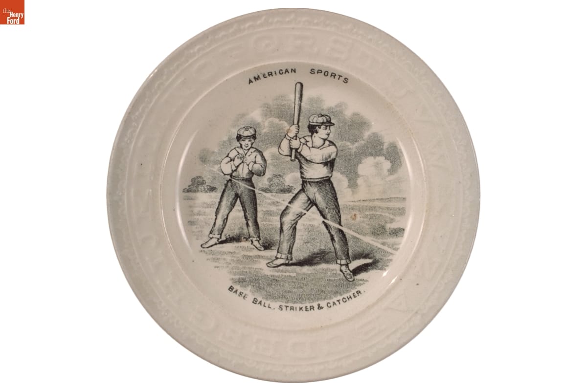 Plate showing a batter holding a baseball bat and a catcher; also contains text