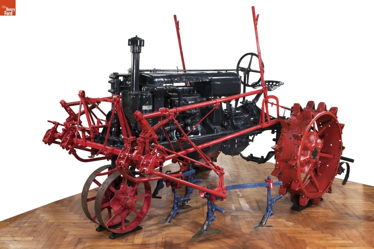 McCormick-Deering Farmall Tractor, circa 1925 Gray tractor with red wheels and attachments along side and front