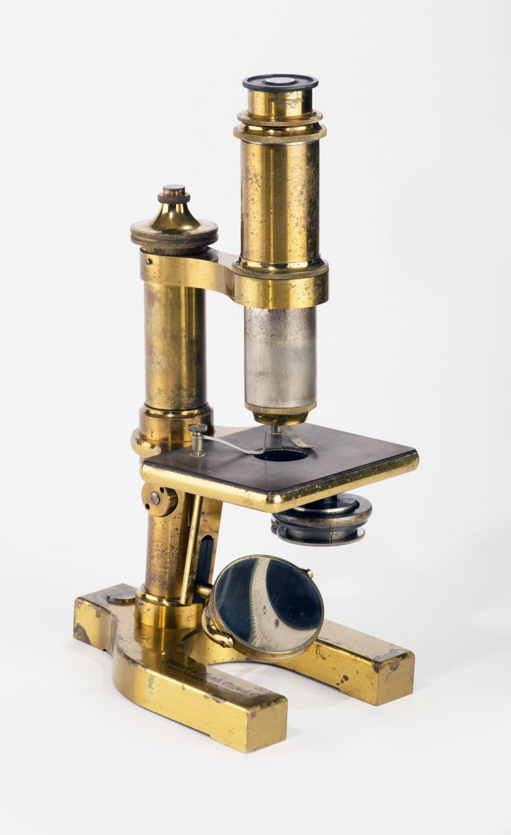 Microscope Used by George Washington Carver, circa 1900 Brass microscope with long viewing tube, flat platform for specimens, and heavy brass feet