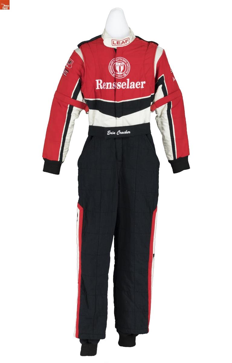 Jumpsuit with black pants with red trim on sides and red, black, and white bodice and sleeves containing text