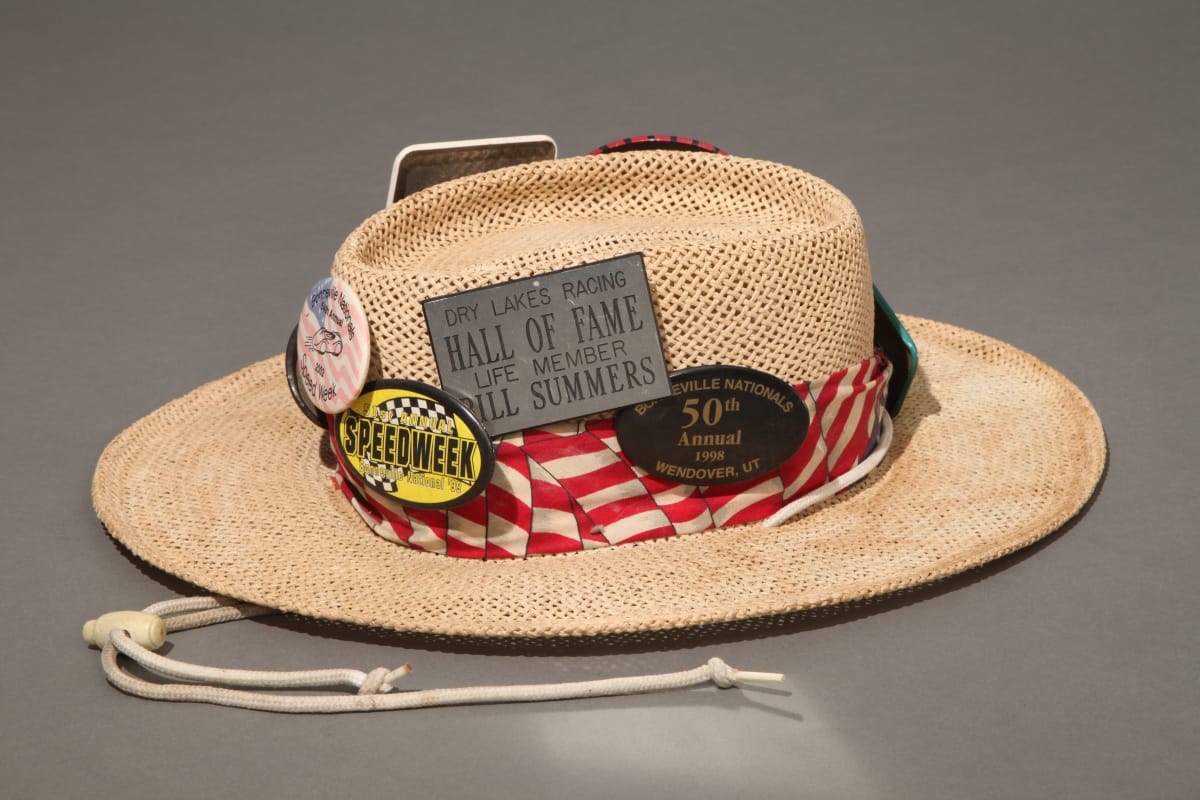 Hat Worn by Bill Summers, circa 1982 Straw hat with red and white striped band and many buttons and badges containing text and images