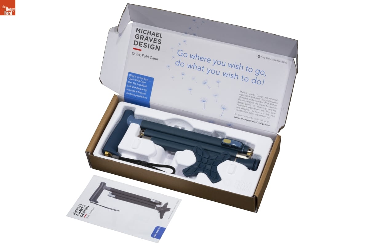 Box with black plastic item in foamcore inside and text inside top flap; instruction pamphlet sitting in front of box