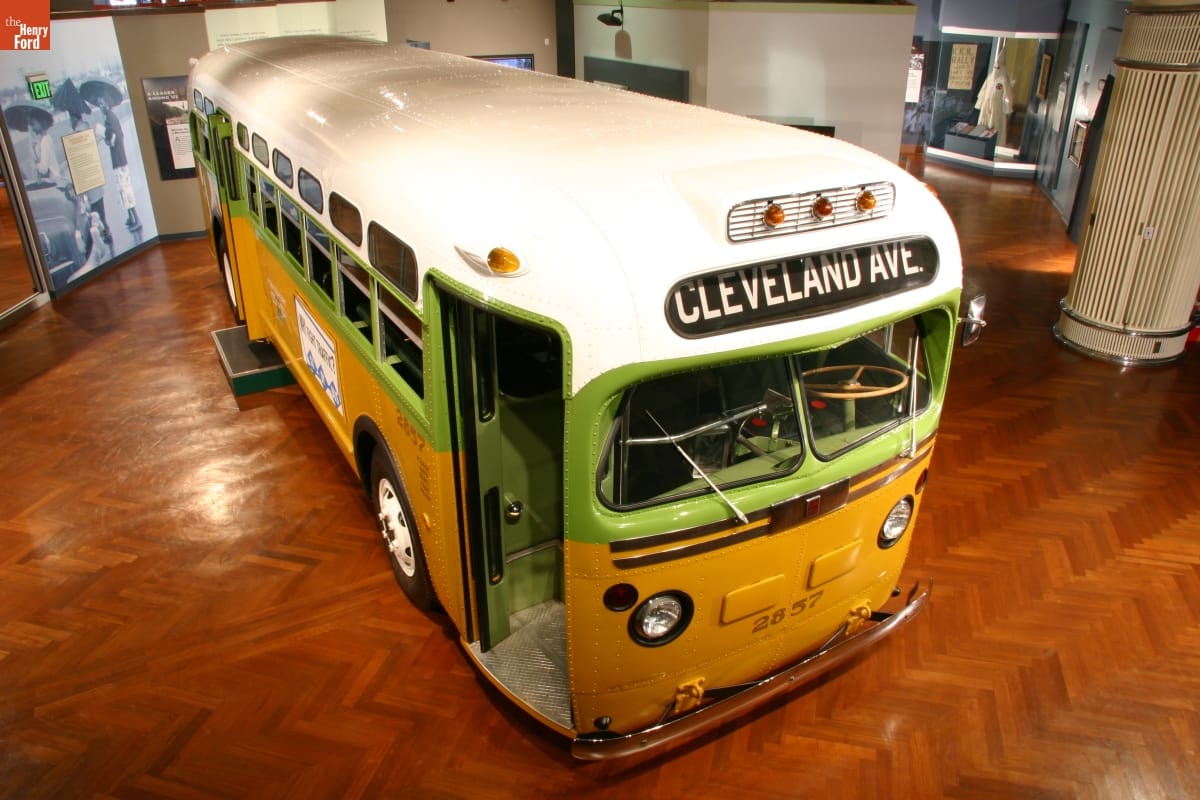 Rosa Parks Bus Angled, aerial view of gold, green, and white bus in museum exhibit