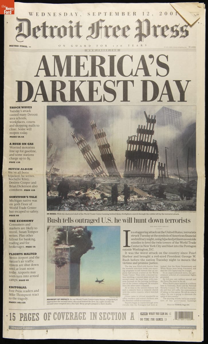 Newspaper front page with headline "America's Darkest Day," text, and images of wreckage and airplane near a smoking building