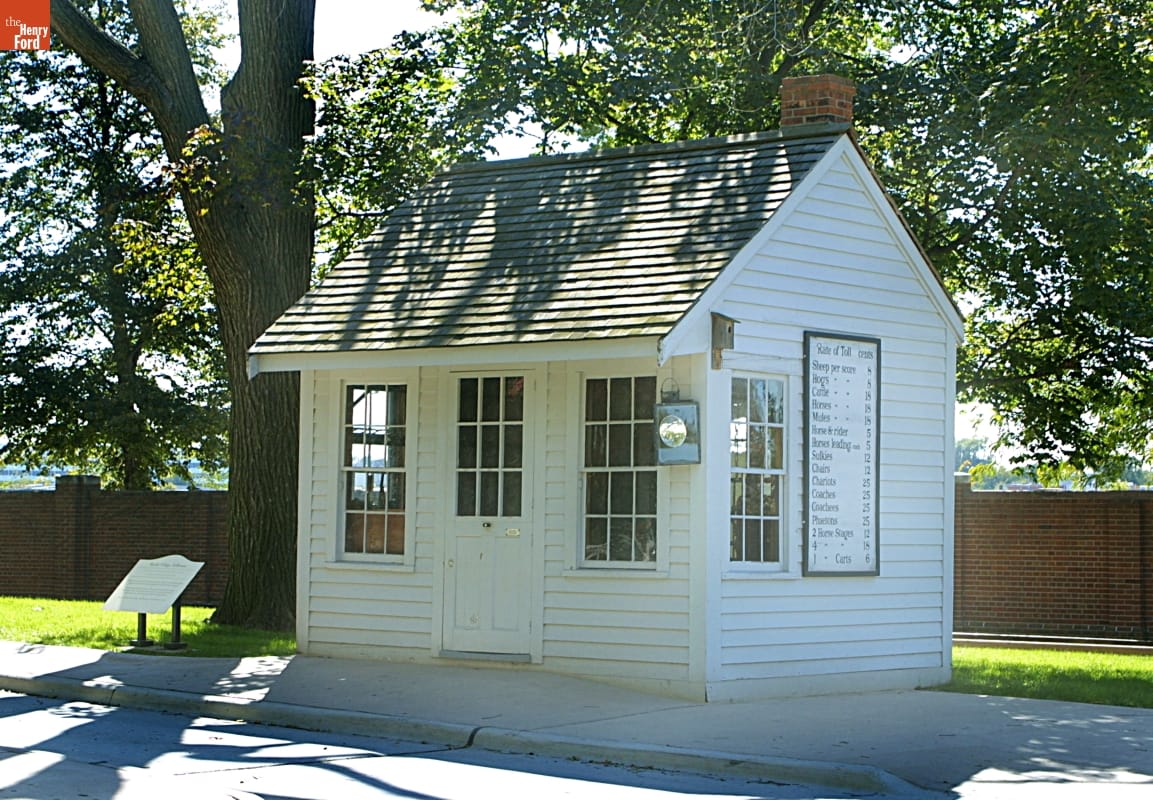 Small white wooden building with several windows