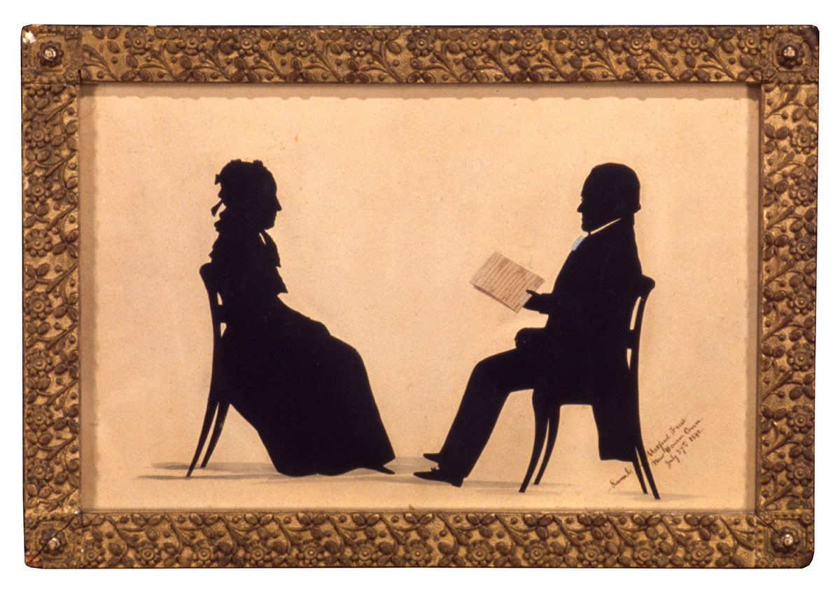 Silhouettes of seated man and woman facing each other